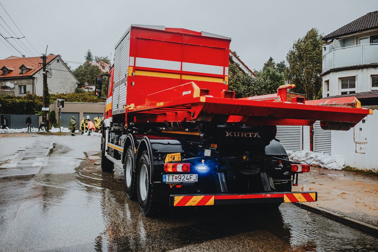red-tow-truck-in-urban-setting-on-rainy-day-28447796